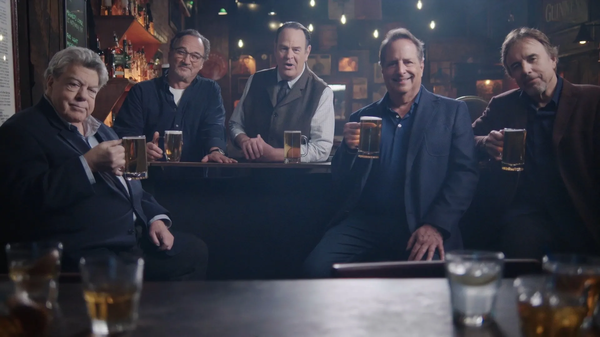 The cast raising glasses at the bar, from A History of the World in Six Glasses